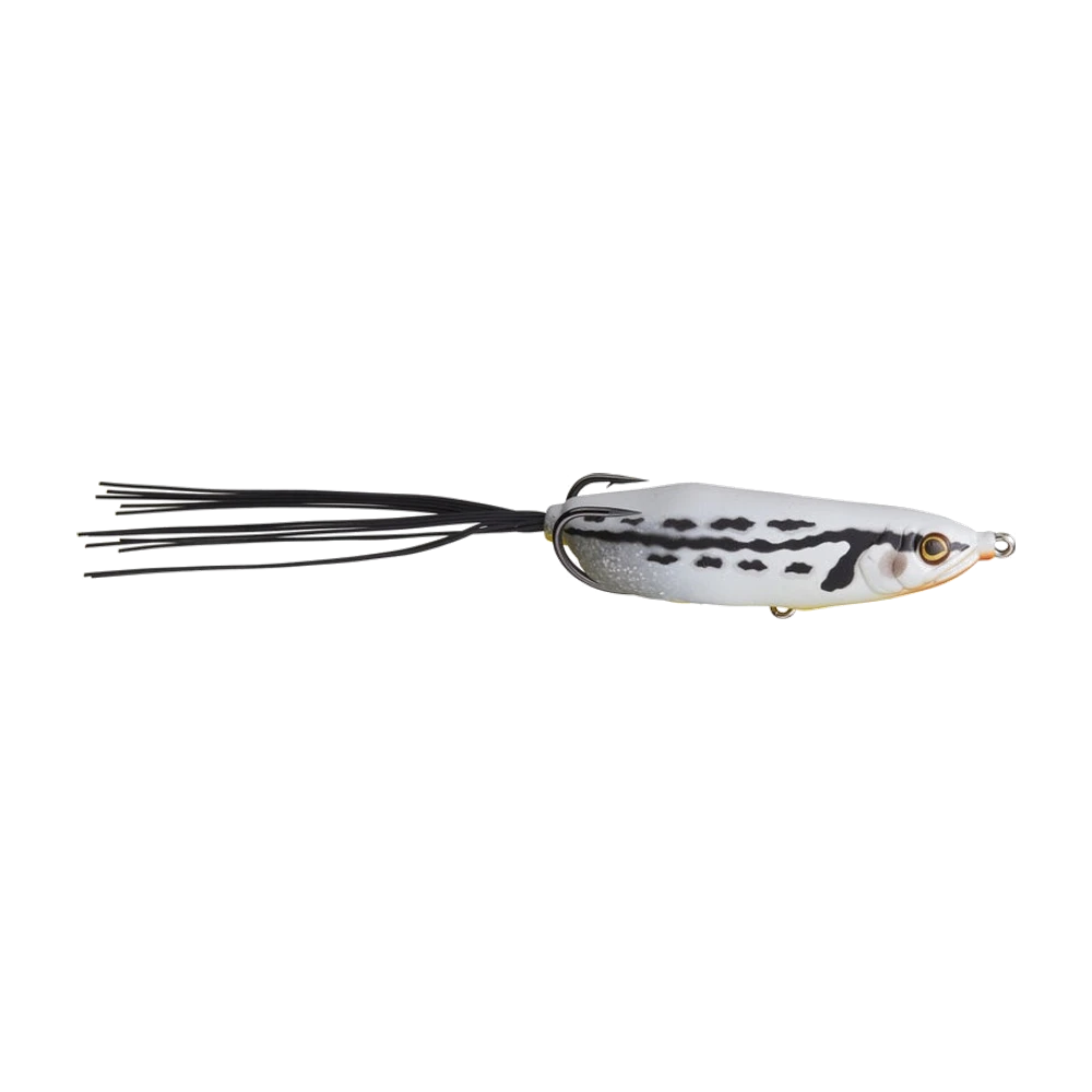 Gan Craft DANGOKU Frog blanc marbré de noir, corps creux effilé, œil ambré, gorge orangée, hameçon double doré rabattu sur le dos, anneau ventral apparent sous le corps, longue jupe silicone noire