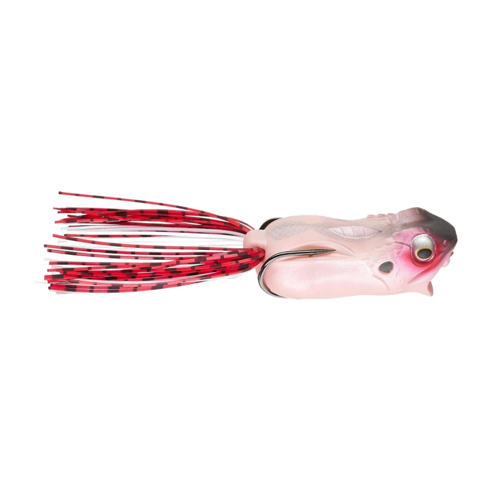 Megabass Gabarin Jr. Frog de profil, corps creux rose chair au sommet du crâne gris sombre, œil argenté cerclé de rose, double hameçon noir plaqué sur le dos pointes vers l'avant, jupe silicone rouge barrée de noir et de blanc