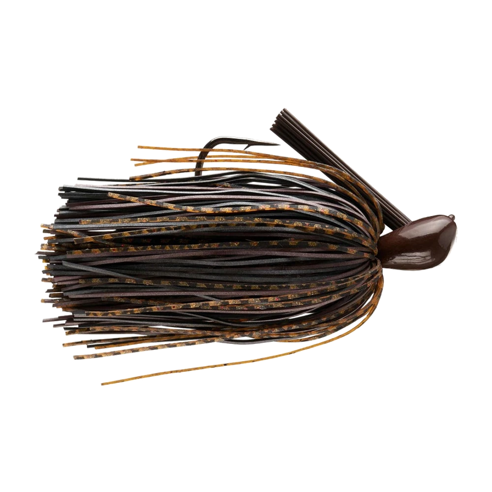 Picasso Old School Dock Rocket Jig, tête compacte laquée brun foncé, garde-herbe en brosse de fibres brunes relevé, hameçon simple noir pointe vers le haut, jupe mêlant brins de caoutchouc plat mats et brins silicone ambrés à paillettes cuivre